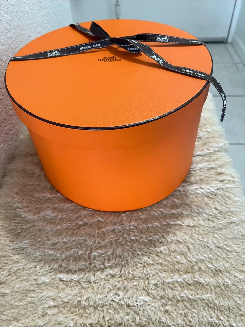 Original Hermès Orange Round Hat Box with branded brown ribbon